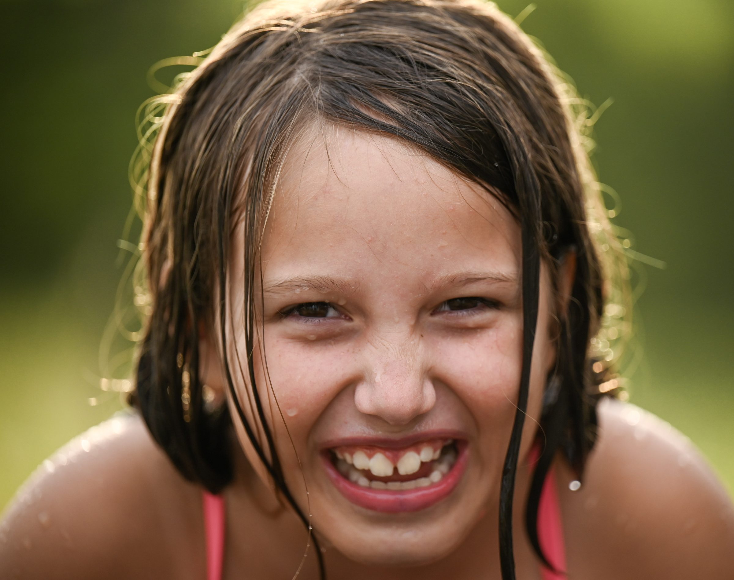 Laughing child playing in the water during a family photography session